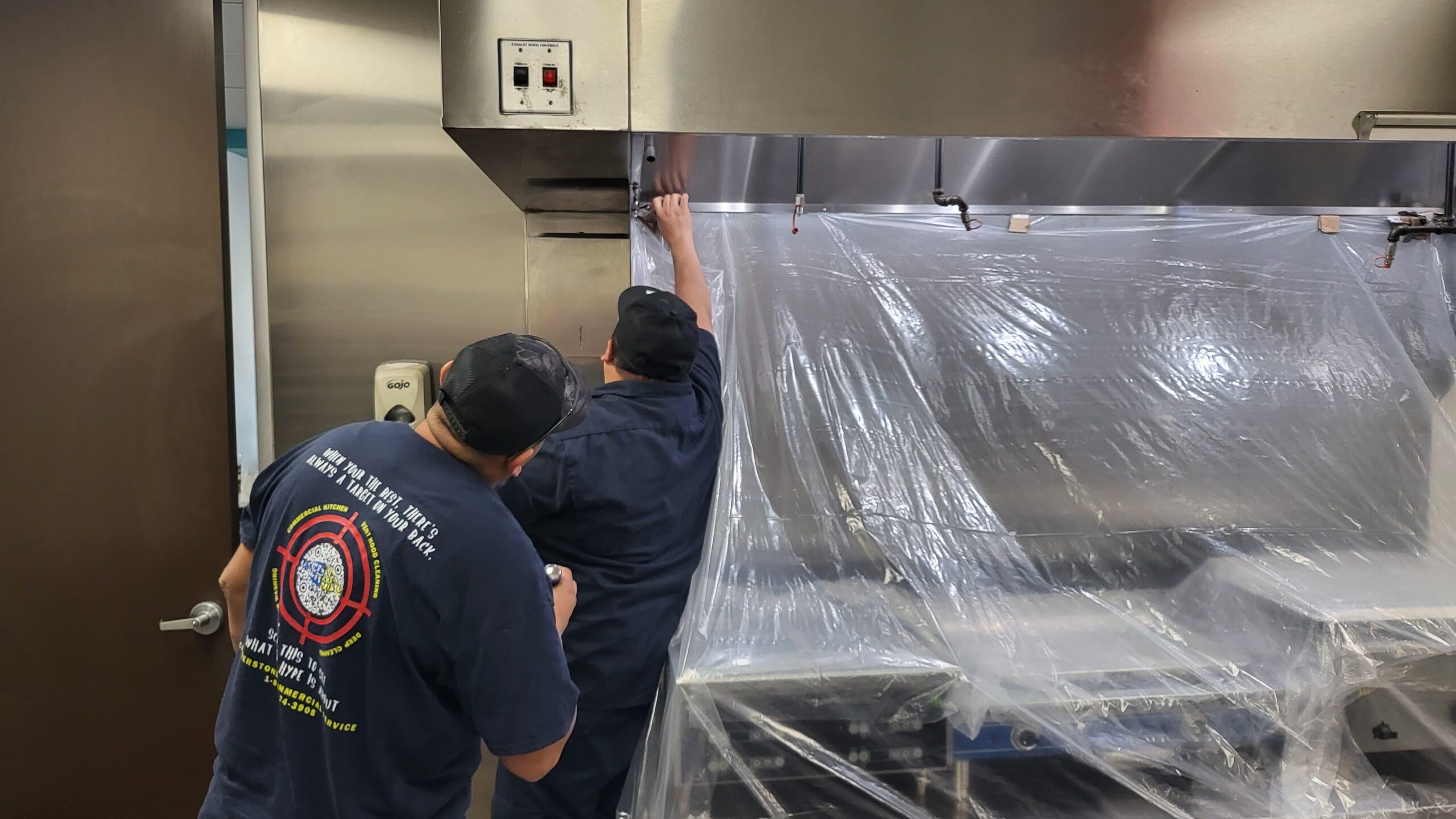 Cornerstone technician scrubbing a kitchen exhaust hood